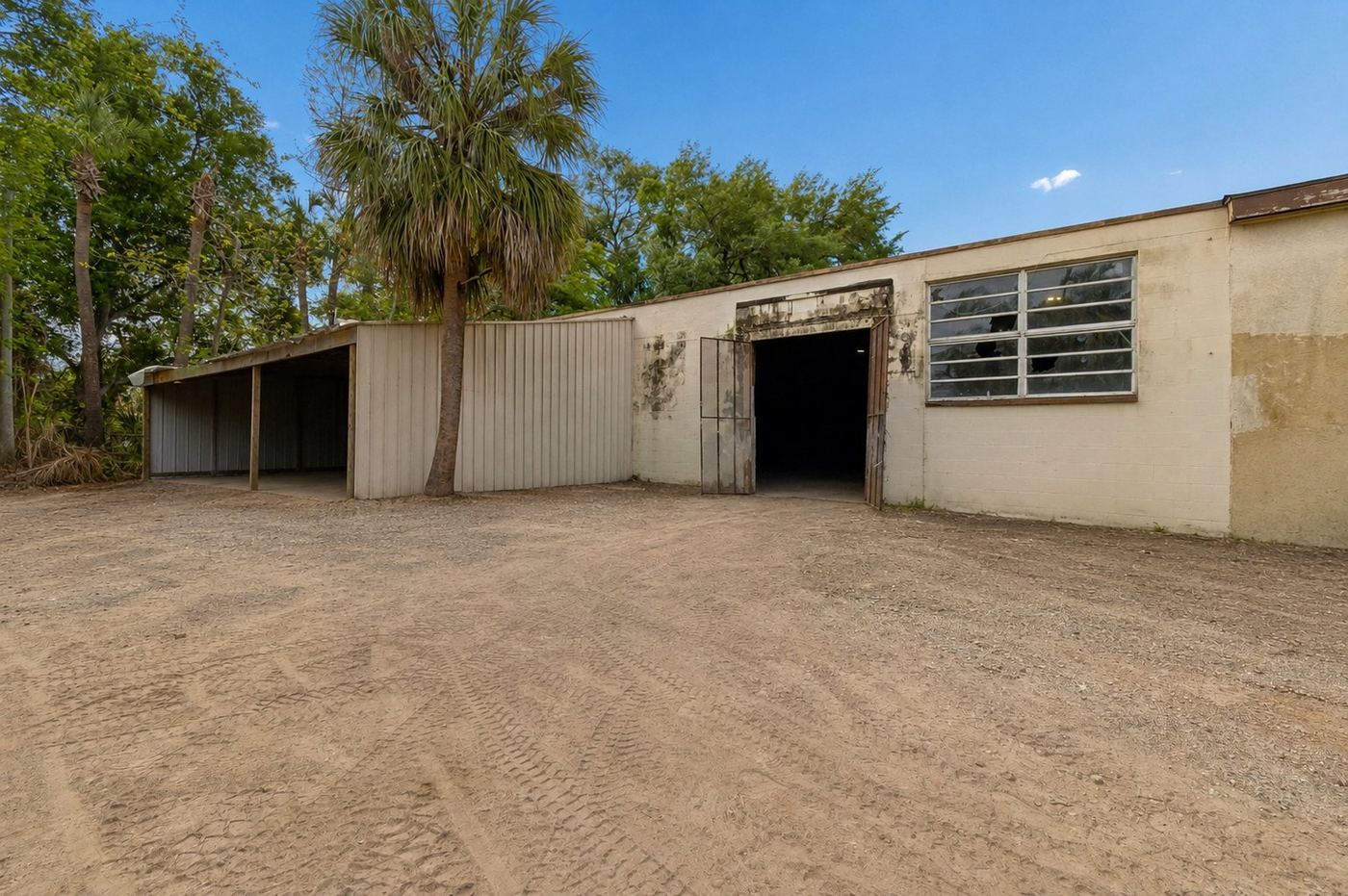Current condition: covered bays and rear yard with unpaved surface